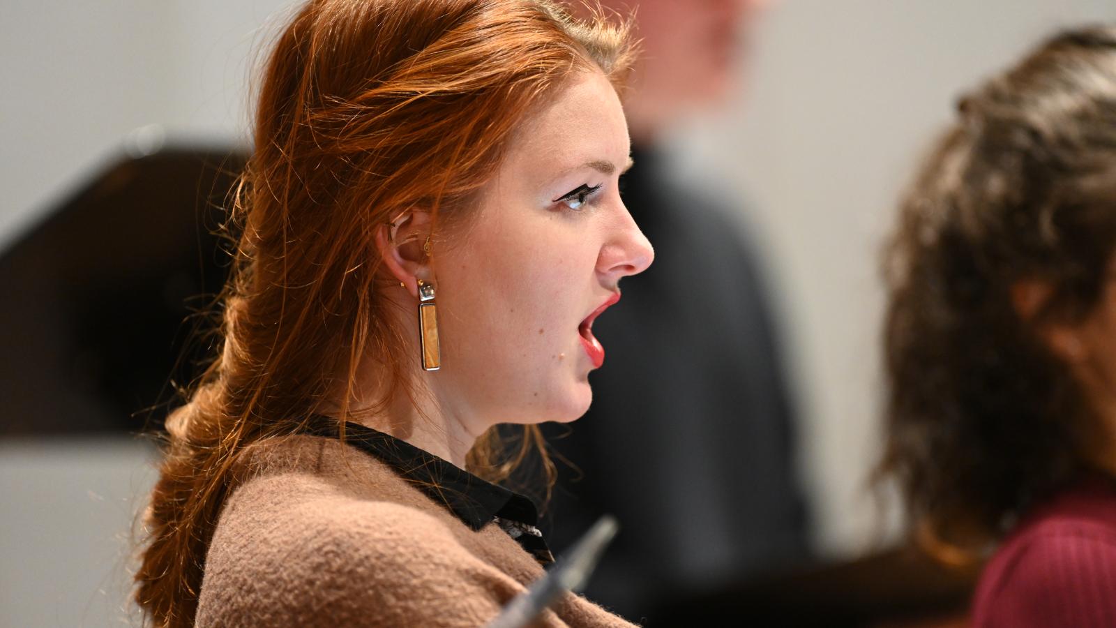 Eine Nahaufnahme einer singenden Gesangsstudentin.