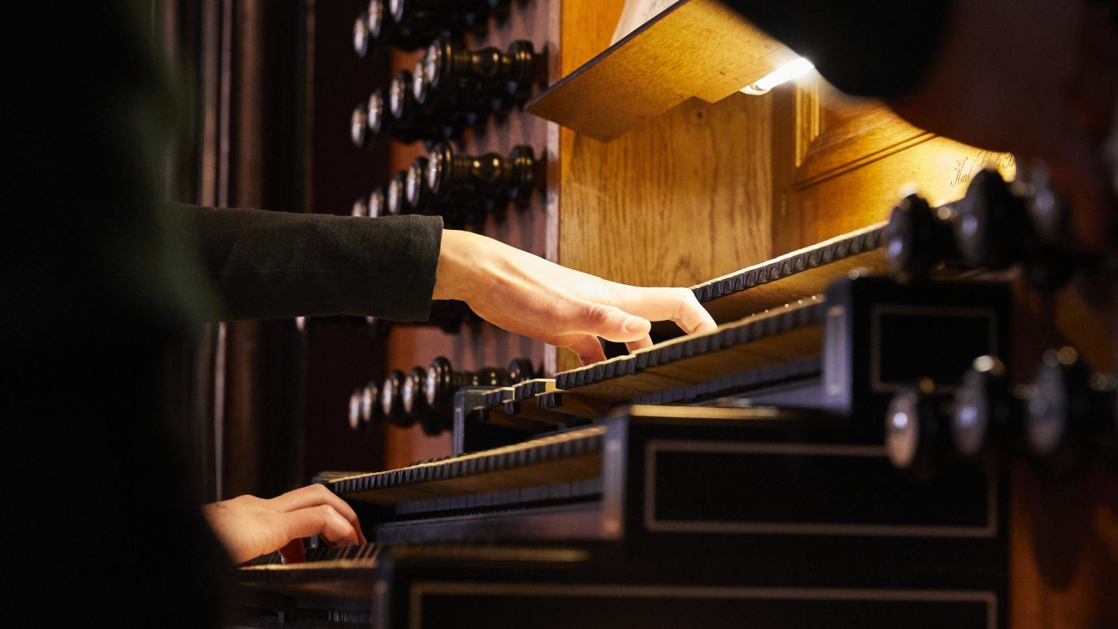 Blick auf eine Orgel spielende Studentin